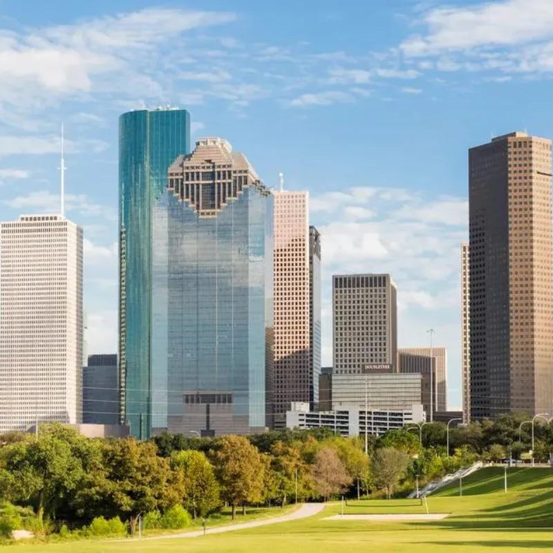 Downtown skyscrapers with green park foreground.