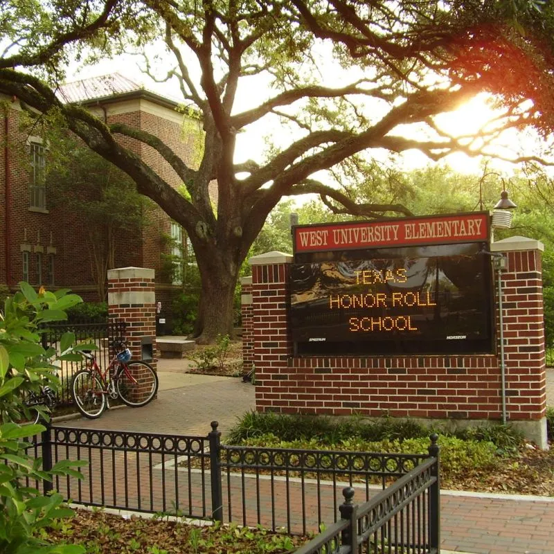 West University Elementary School entrance sign with tree.