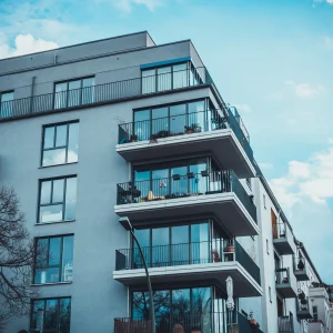 Modern apartment building with balconies beneath blue sky